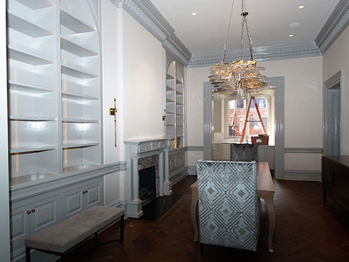 photo of dining room with fireplace to the left surrounded by cabinets painted in light blue from Fine Paints of Europe
