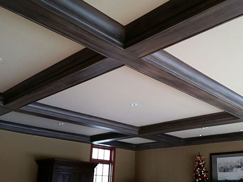photo of mahogany stained natural wood exposed beams criss crossing a white ceiling