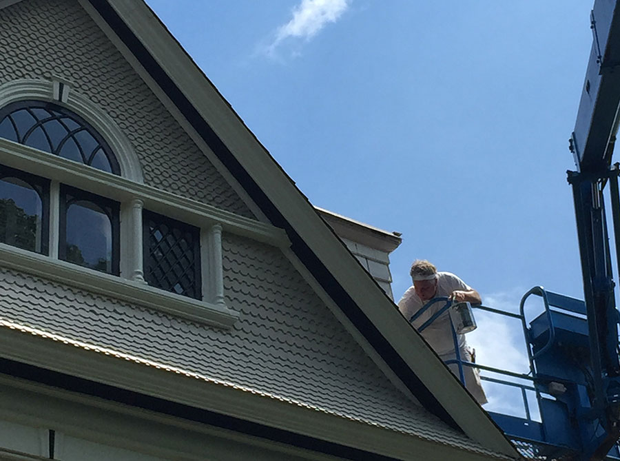 photo of gabled roof on victorian home with  half-cove cedar shakes painted yellow